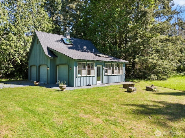 5513 Homestead Ln, Anacortes, WA 98221 - view of front of property with a shingled roof, a front yard, driveway, and an outdoor fire pit