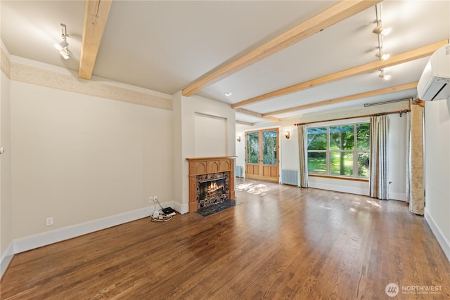 5513 Homestead Ln, Anacortes, WA 98221 - unfurnished living room featuring beamed ceiling, an AC wall unit, wood finished floors, a fireplace with flush hearth, and radiator heating unit