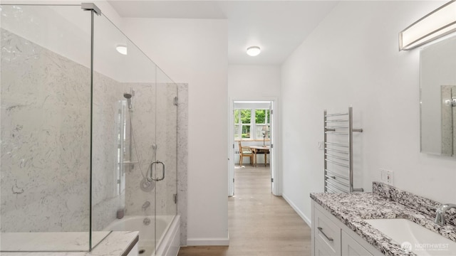 5513 Homestead Ln, Anacortes, WA 98221 - bathroom featuring radiator, a shower with door, a bathtub, vanity, and wood finished floors