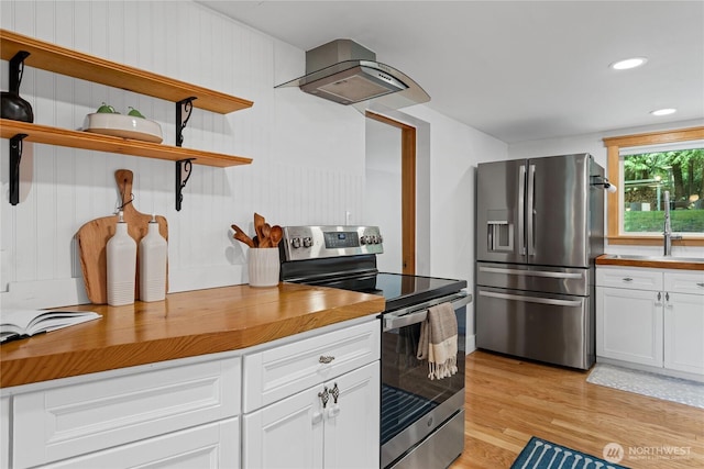 3555 S Holmes View Dr, Langley, WA 98260 - kitchen with stainless steel appliances, range hood, butcher block countertops, light wood-style floors, and open shelves