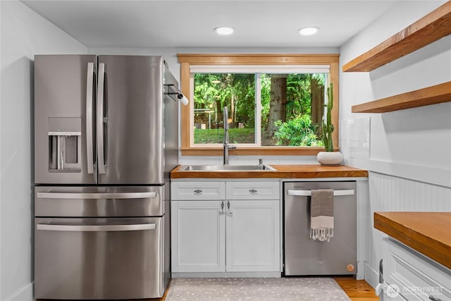 3555 S Holmes View Dr, Langley, WA 98260 - kitchen with appliances with stainless steel finishes, white cabinets, open shelves, and wood counters