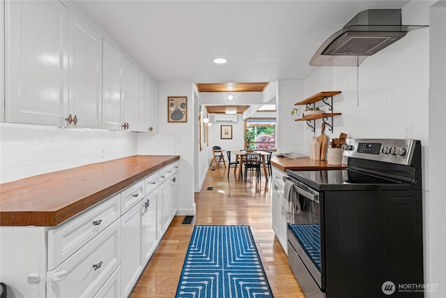 3555 S Holmes View Dr, Langley, WA 98260 - kitchen with electric stove, butcher block counters, light wood finished floors, white cabinetry, and recessed lighting