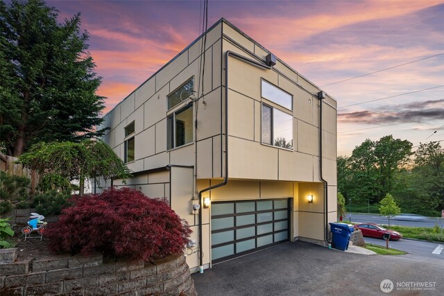 7528 21st Ave SW, Seattle, WA 98106 - modern home featuring an attached garage, driveway, and stucco siding