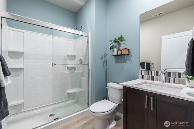 11433 SE 84th St Unit 41, Newcastle, WA 98056 - full bathroom with a stall shower, vanity, wood finished floors, and decorative backsplash