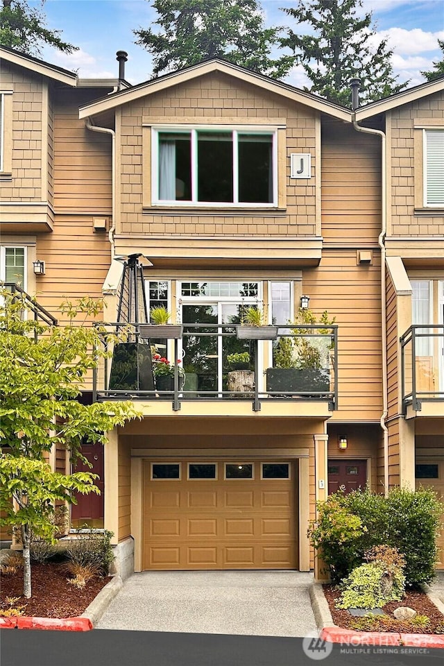 23300 SE Black Nugget Rd Unit J3, Issaquah, WA 98029 - view of property featuring a balcony, a garage, and driveway