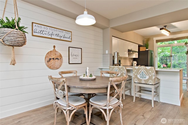 23300 SE Black Nugget Rd Unit J3, Issaquah, WA 98029 - dining room featuring light wood-style flooring and wooden walls