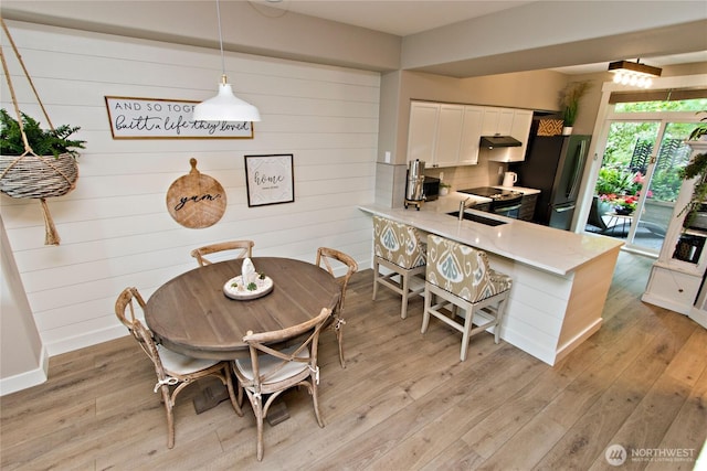 23300 SE Black Nugget Rd Unit J3, Issaquah, WA 98029 - dining area featuring light wood-style flooring and wooden walls