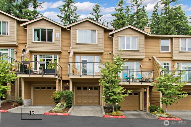 23300 SE Black Nugget Rd Unit J3, Issaquah, WA 98029 - townhome / multi-family property featuring an attached garage, asphalt driveway, and a chimney