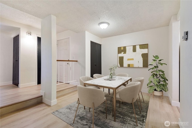 17514 151st Ave SE Unit 1-4, Renton, WA 98058 - dining area with wood finished floors and a textured ceiling