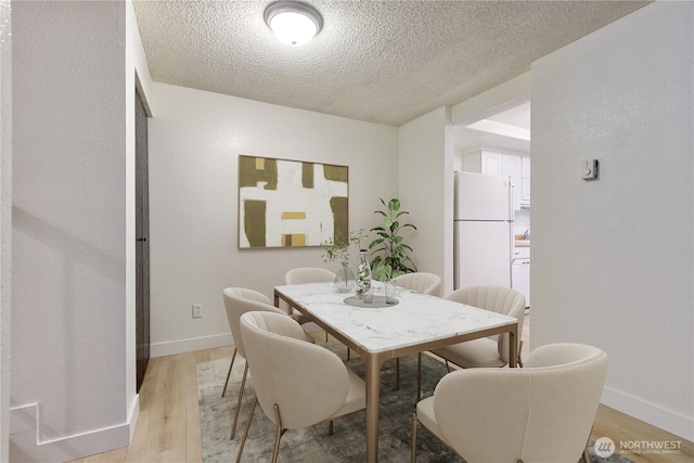 17514 151st Ave SE Unit 1-4, Renton, WA 98058 - dining space featuring light wood-style flooring and a textured ceiling