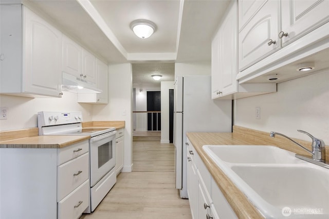 17514 151st Ave SE Unit 1-4, Renton, WA 98058 - kitchen with white electric range, under cabinet range hood, light wood-style flooring, and white cabinets