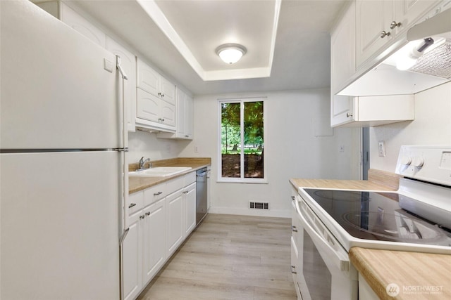 17514 151st Ave SE Unit 1-4, Renton, WA 98058 - kitchen featuring white appliances, under cabinet range hood, light countertops, white cabinetry, and light wood-style flooring