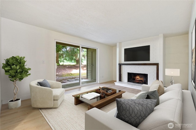 17514 151st Ave SE Unit 1-4, Renton, WA 98058 - living area featuring wood finished floors and a brick fireplace
