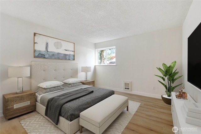 17514 151st Ave SE Unit 1-4, Renton, WA 98058 - bedroom featuring light wood finished floors, a textured ceiling, and heating unit