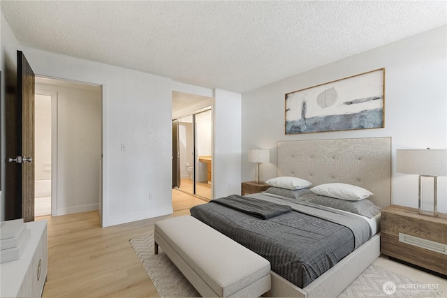 17514 151st Ave SE Unit 1-4, Renton, WA 98058 - bedroom with light wood-style floors, a textured ceiling, ensuite bathroom, and a closet