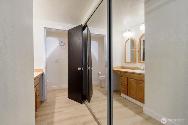 17514 151st Ave SE Unit 1-4, Renton, WA 98058 - bathroom featuring vanity and wood finished floors