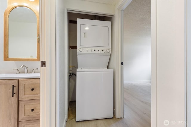 17514 151st Ave SE Unit 1-4, Renton, WA 98058 - laundry area with stacked washing machine and dryer and light wood-style flooring
