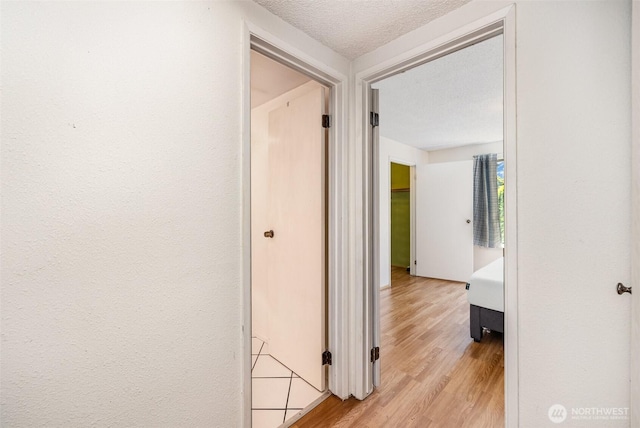 17529 151st Ave SE Unit 7-6, Renton, WA 98058 - corridor featuring light wood-type flooring and a textured ceiling