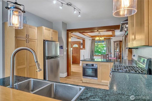 4222 Latona Ave NE, Seattle, WA 98105 - kitchen with stainless steel appliances, light brown cabinetry, and decorative light fixtures