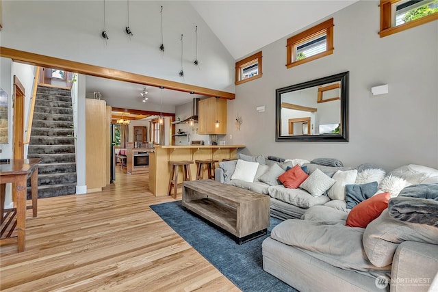 4222 Latona Ave NE, Seattle, WA 98105 - living area with high vaulted ceiling, light wood-type flooring, and stairs
