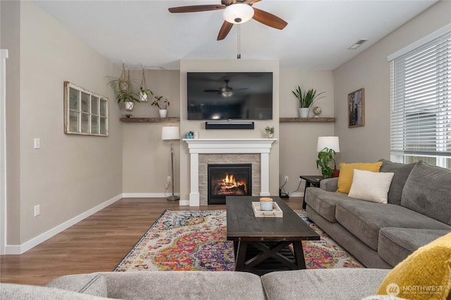 3294 Prill Rd, Centralia, WA 98531 - living room featuring ceiling fan, wood finished floors, and a warm lit fireplace