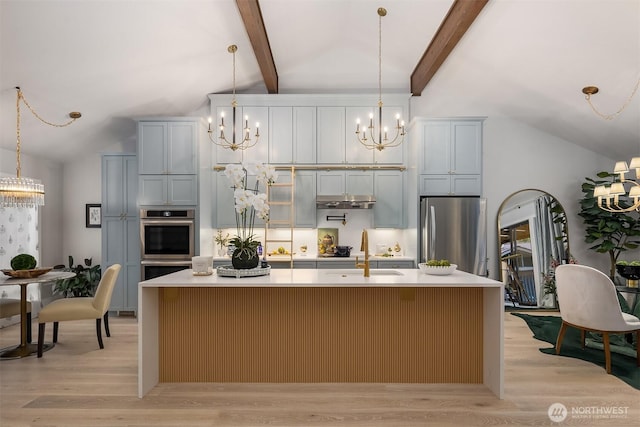 1518 NE 140th St Unit C6, Seattle, WA 98125 - kitchen with a chandelier, appliances with stainless steel finishes, a center island with sink, light wood-type flooring, and light countertops