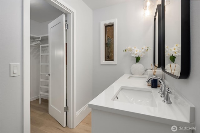 1518 NE 140th St Unit C6, Seattle, WA 98125 - full bath featuring wood finished floors, double vanity, and a walk in closet