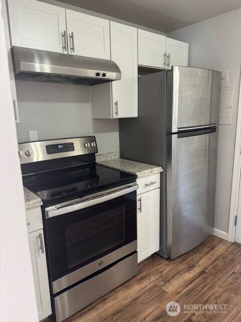 330 SW 5th Ave Unit 336, Ephrata, WA 98823 - kitchen featuring appliances with stainless steel finishes, under cabinet range hood, white cabinetry, dark wood-style floors, and light stone countertops