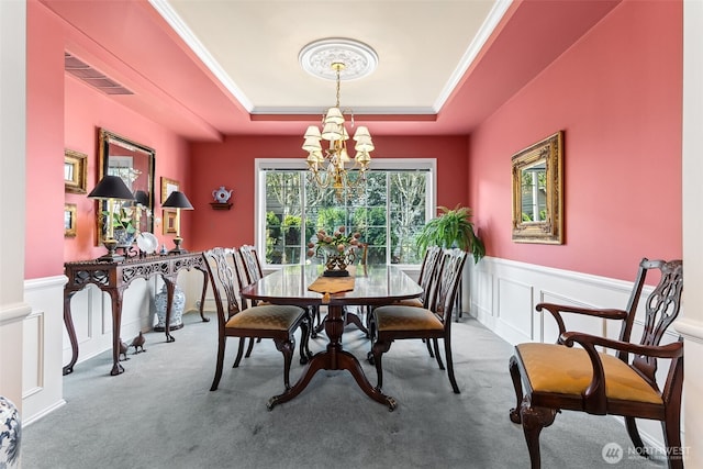 5422 21st Avenue Ct NE, Tacoma, WA 98422 - carpeted dining room featuring a chandelier, a raised ceiling, wainscoting, and a decorative wall