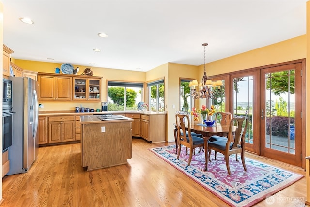 5422 21st Avenue Ct NE, Tacoma, WA 98422 - kitchen featuring stainless steel refrigerator with ice dispenser, a center island, stovetop, light countertops, and light wood finished floors