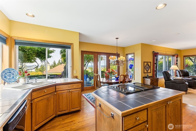 5422 21st Avenue Ct NE, Tacoma, WA 98422 - kitchen featuring tile counters, black appliances, light wood-style flooring, a chandelier, and recessed lighting