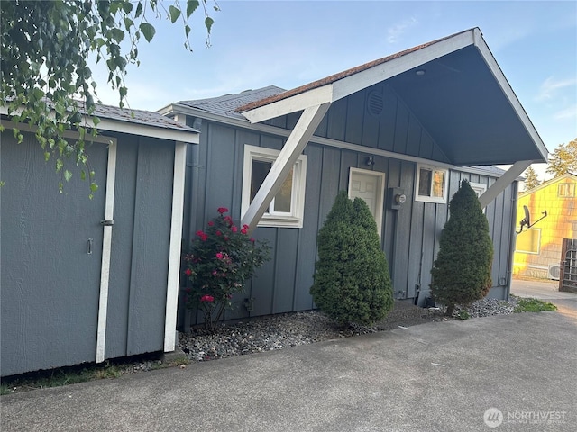 1421 Fairmount Ave, Shelton, WA 98584 - view of home's exterior with board and batten siding, an outdoor structure, and a shingled roof