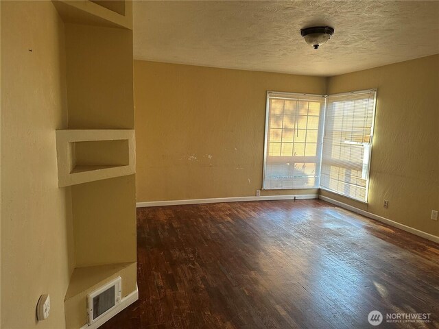 1421 Fairmount Ave, Shelton, WA 98584 - empty room featuring wood finished floors, a textured ceiling, and a textured wall