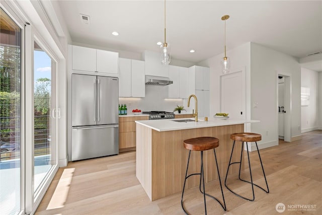 6732 21st Ave SW, Seattle, WA 98106 - kitchen with high quality fridge, extractor fan, light wood-style flooring, healthy amount of natural light, and recessed lighting