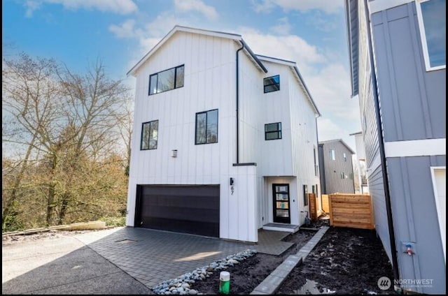 6732 21st Ave SW, Seattle, WA 98106 - modern farmhouse featuring an attached garage, board and batten siding, and driveway