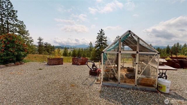 76 Buck Rd, Wauconda, WA 98859 - view of play area with an exterior structure, an outbuilding, and a mountain view