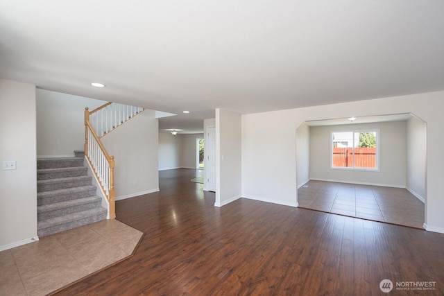 510 Trout Ave NE, Moses Lake, WA 98837 - unfurnished living room featuring dark wood-style flooring, healthy amount of natural light, stairway, and recessed lighting