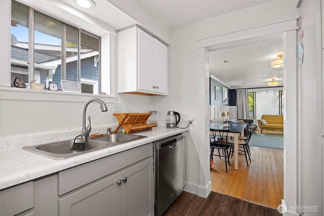 2413 Queen St, Bellingham, WA 98229 - kitchen with stainless steel dishwasher, light countertops, dark wood-type flooring, and white cabinets