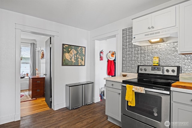 2413 Queen St, Bellingham, WA 98229 - kitchen with stainless steel range with electric cooktop, under cabinet range hood, backsplash, dark wood-style flooring, and white cabinets