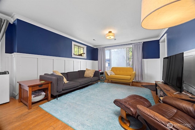 2413 Queen St, Bellingham, WA 98229 - living area featuring crown molding, light wood-type flooring, a decorative wall, and wainscoting