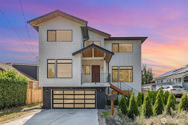 6209 32nd Ave NE, Seattle, WA 98115 - modern home featuring a garage, concrete driveway, and stairway