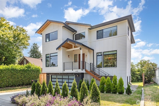 6209 32nd Ave NE, Seattle, WA 98115 - contemporary house featuring an attached garage, stairway, and board and batten siding