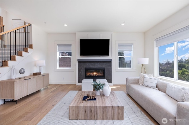 6209 32nd Ave NE, Seattle, WA 98115 - living area featuring light wood-style floors, stairs, a glass covered fireplace, and recessed lighting