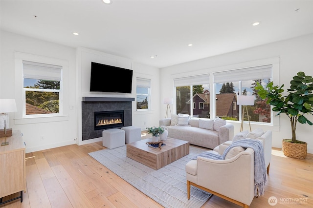 6209 32nd Ave NE, Seattle, WA 98115 - living room featuring healthy amount of natural light, a glass covered fireplace, light wood finished floors, and recessed lighting