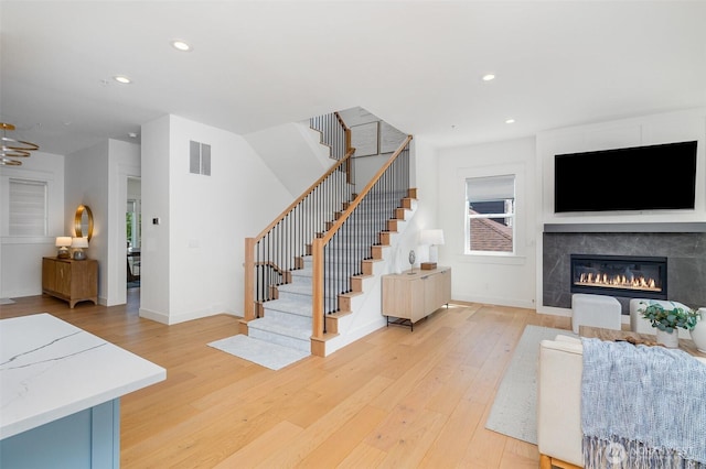 6209 32nd Ave NE, Seattle, WA 98115 - living room featuring light wood-style floors, stairs, recessed lighting, and a glass covered fireplace