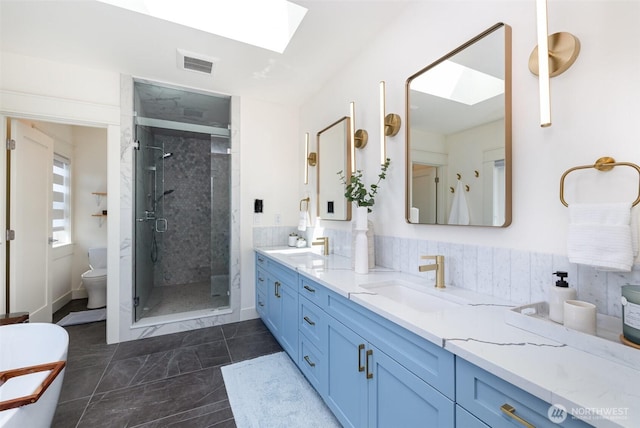 6209 32nd Ave NE, Seattle, WA 98115 - bathroom with a skylight, double vanity, a stall shower, and a freestanding tub
