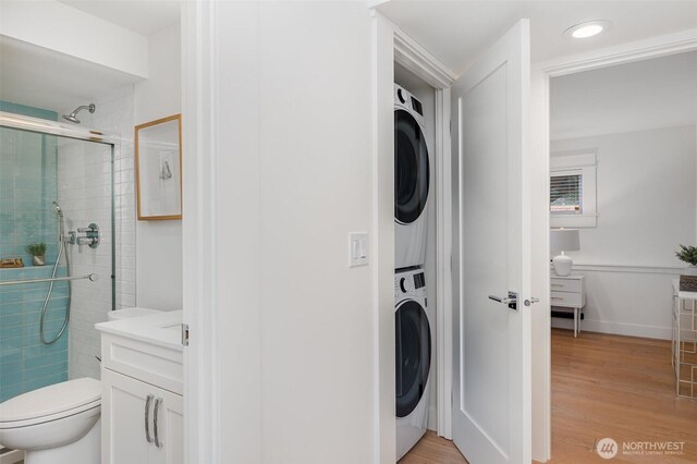 6209 32nd Ave NE, Seattle, WA 98115 - laundry room featuring estacked washer and dryer, light wood finished floors, and recessed lighting