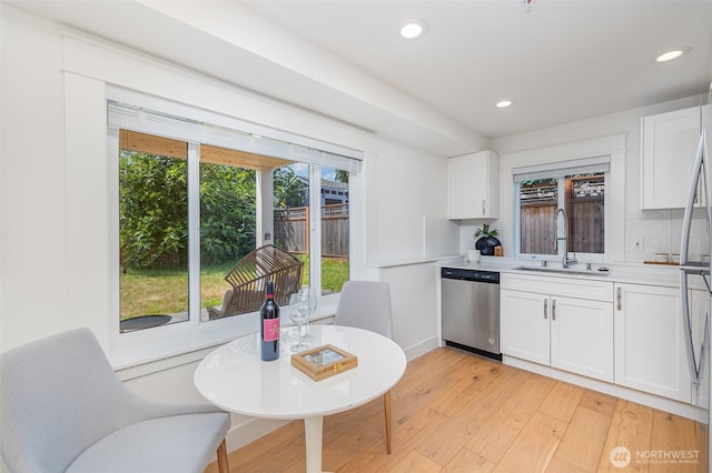 6209 32nd Ave NE, Seattle, WA 98115 - kitchen featuring appliances with stainless steel finishes, tasteful backsplash, white cabinetry, and recessed lighting