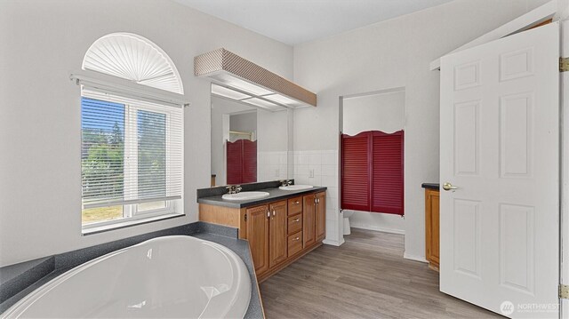 41427 Mountain View Pl E, Gold Bar, WA 98251 - full bath featuring double vanity, a tub, and wood finished floors