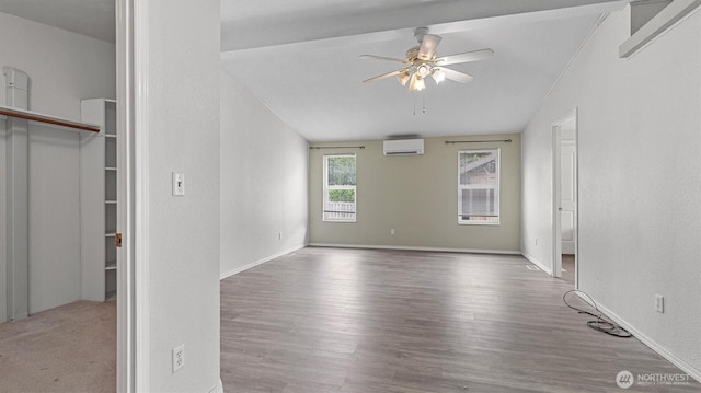 41427 Mountain View Pl E, Gold Bar, WA 98251 - spare room featuring a wall mounted AC, a ceiling fan, and wood finished floors